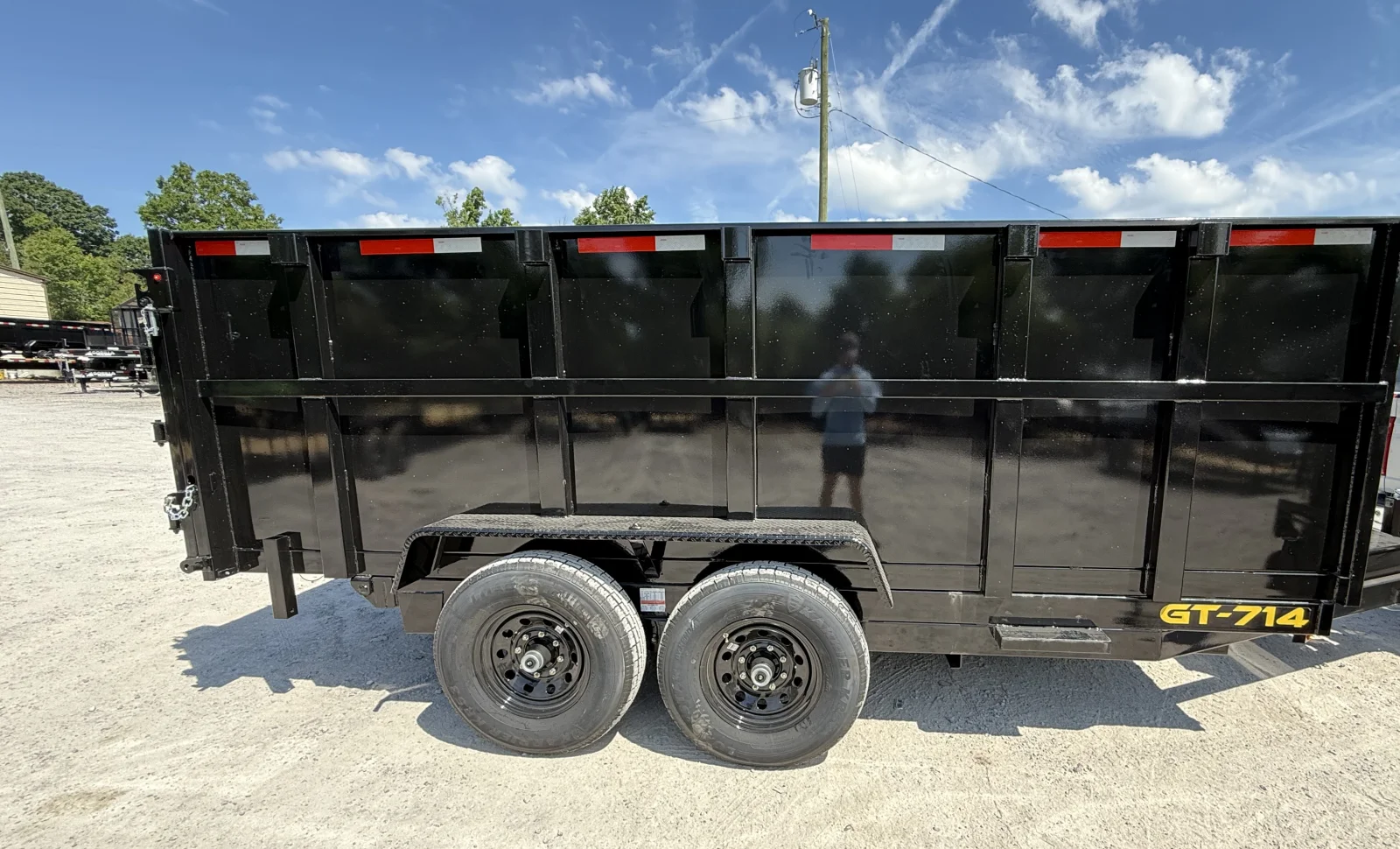 Tilt Dumpsters' 7-by-14 dump trailer parked on gravel in North Alabama.
