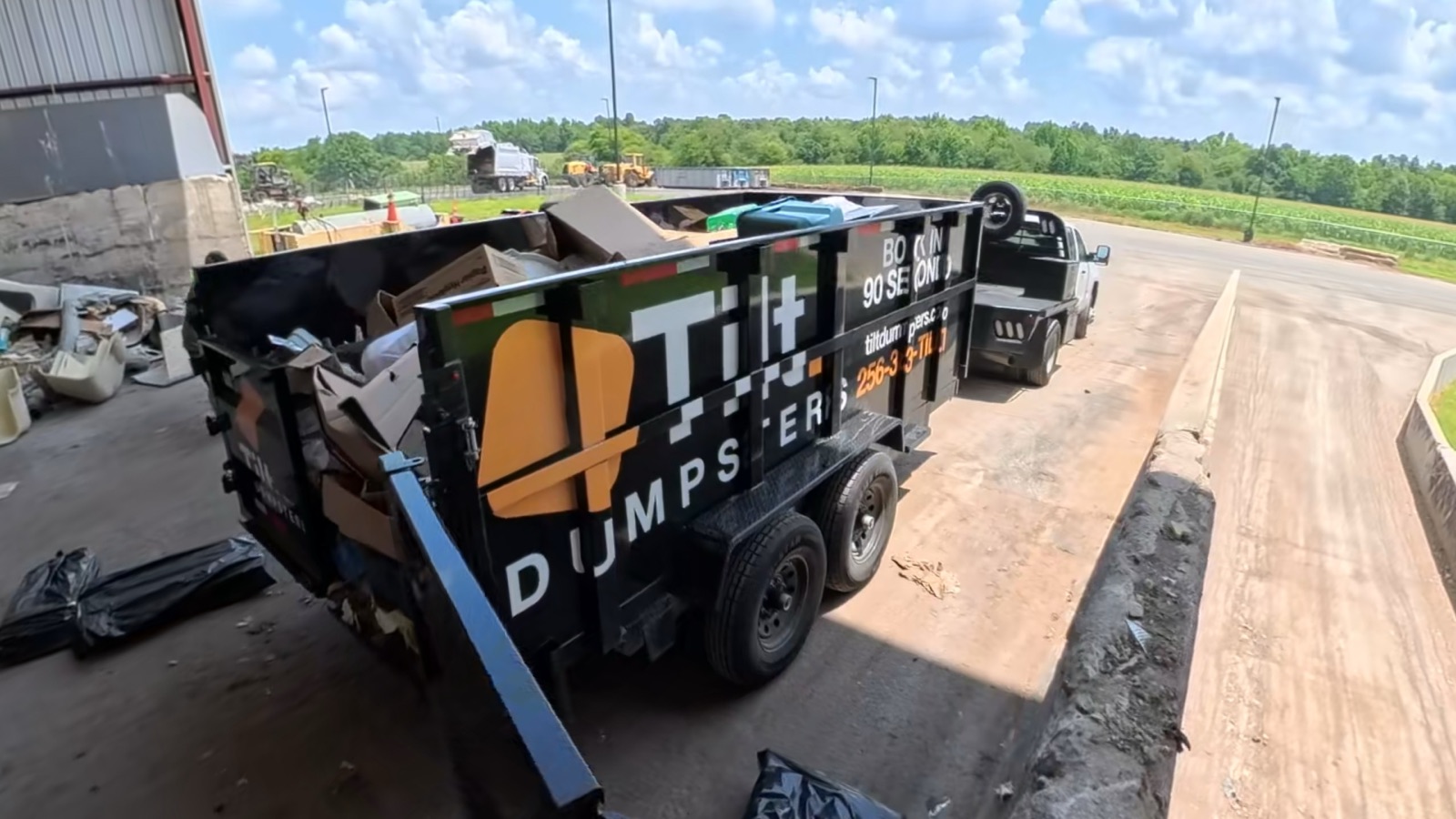 The Tilt Dumpsters trailer filled with a customer's load, hitched and ready to haul